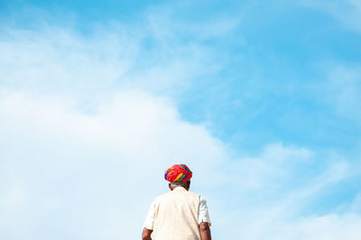 Rear view of man against sky