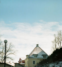 Houses by street in town against sky