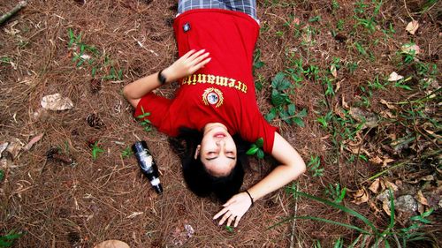 High angle view of woman lying on field