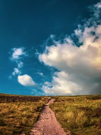 Dirt road along countryside landscape