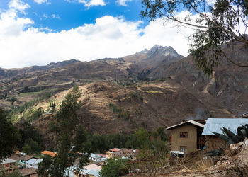 Scenic view of mountains and houses against sky