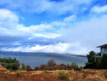 Scenic view of sea and houses against sky