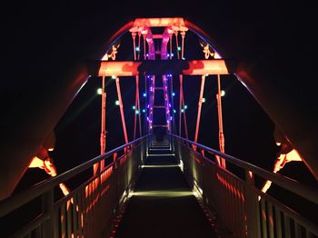 Illuminated bridge at night