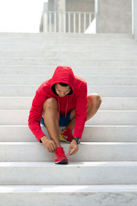 Portrait of man sitting on staircase