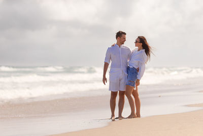 Full length of woman standing at beach