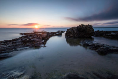 Scenic view of sea against sky during sunset