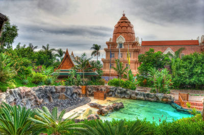 View of temple building against cloudy sky