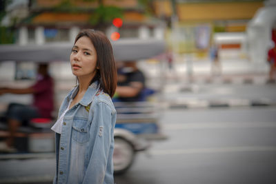 Portrait of young woman standing outdoors