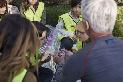 Teachers with school children sitting outside