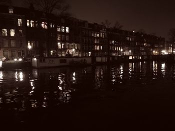 Reflection of illuminated buildings in river at night