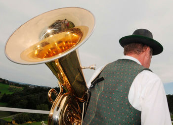 Rear view of man holding hat