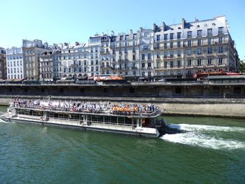 Boats in river with buildings in background