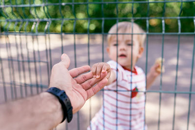 Cute girl holding fathers hand