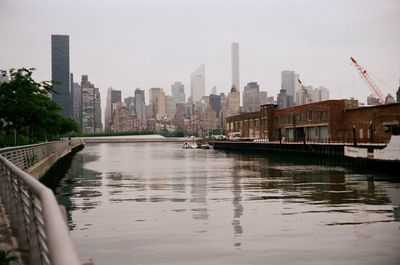 Modern cityscape with river in background