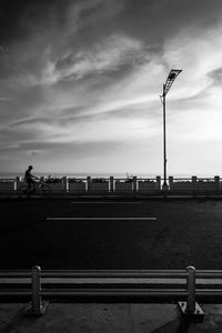 Street light by road against sky