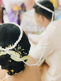 Rear view of people with pink flower