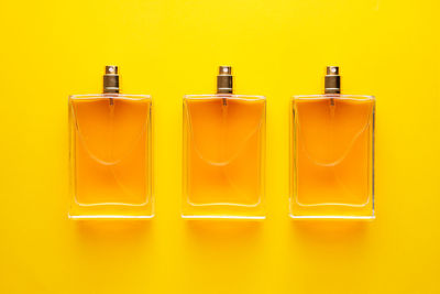Close-up of yellow bottle against orange background