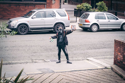 Full length of man standing on street in city