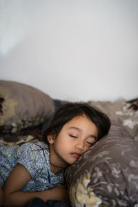 Cute girl relaxing on bed at home