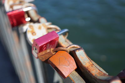 Close-up of love locks on bridge over river
