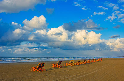 Scenic view of beach against blue sky