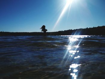 Scenic view of sea against sky on sunny day