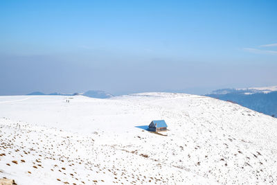 Scenic view of snow covered mountains against sky