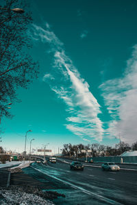 Road by city against sky