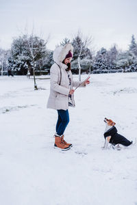 Full length of man standing on snow covered field