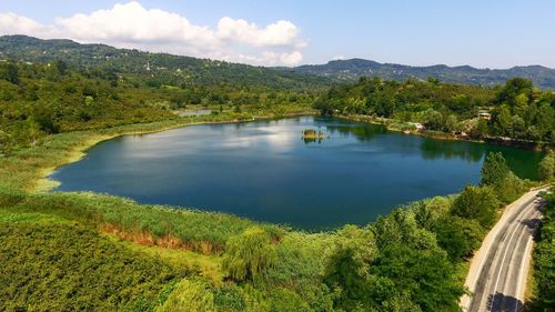 Scenic view of lake and mountains against sky