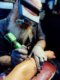 Man scribing stories on skin.