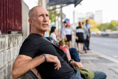 Portrait of man on street in city