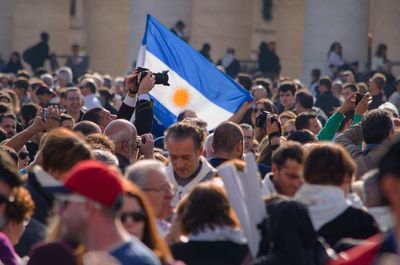 Crowd with argentinian flag at vatican