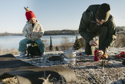 Man preparing food outdoors at winter