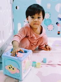 Portrait of cute girl playing with toy blocks