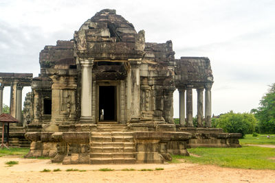 Old ruins of temple against cloudy sky