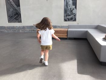 Rear view of young woman walking in park