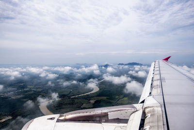 Aerial view of airplane wing against sky