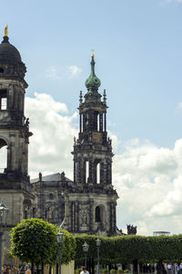 Low angle view of dresden frauenkirche against cloudy sky on sunny day