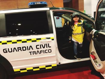 Portrait of girl standing in civil car