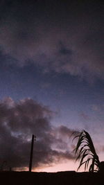 Low angle view of smoke stack against sky at sunset