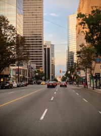 View of city street and buildings against sky