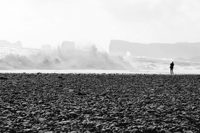 Rear view of man on landscape against sky