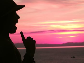 Woman photographing at sunset