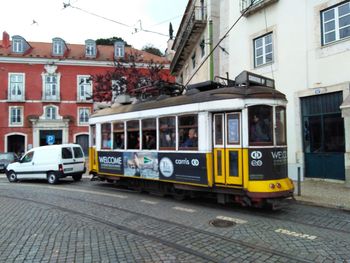 Cars on street by buildings in city