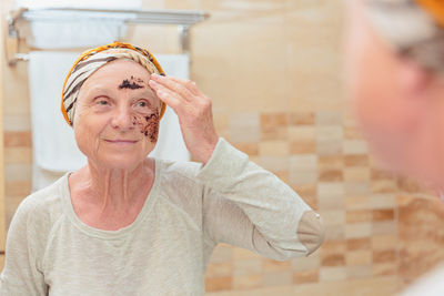 Senior woman taking care of her face