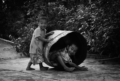 Portrait of boy with brother in drum