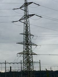 Low angle view of electricity pylon against sky