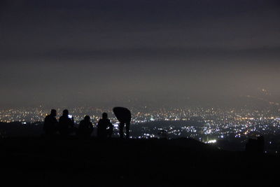 Woman in illuminated city at night