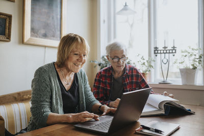 Senior couple using laptop at home